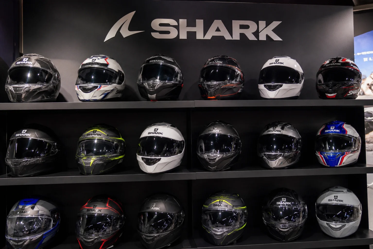 Shark motorcycle helmet lineup displayed in a showroom